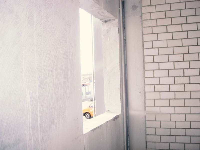 Gesägte Fensteröffnung in einer Betonwand mit glatter Laibung